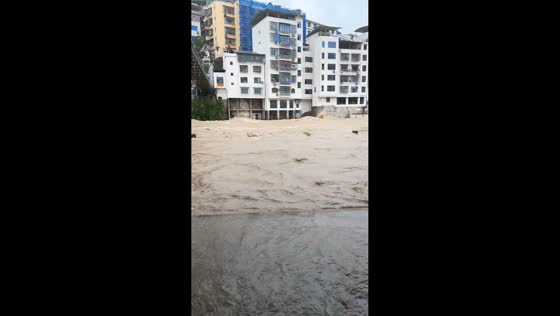 Severe flooding sends waves through a residential area in Chongqing, China