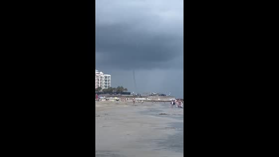 Waterspout forms off the shore as storm passes through beach in Galveston, Texas