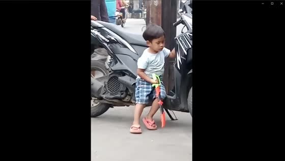 Sleepy little biker boy: a funny moment in Bandung, West Java