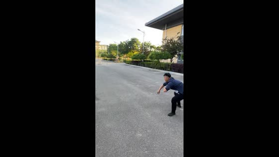 Man plays with dog on street as husky pulls away from leash in Ningxia, China