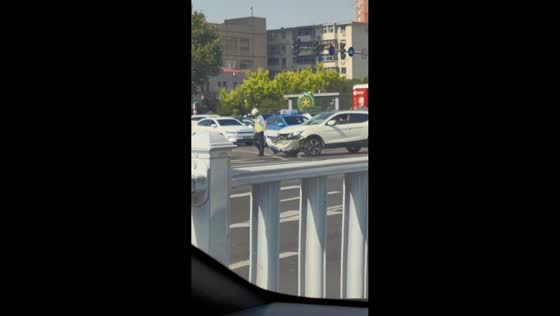 Officer carries broken bumper after crash in Hebei, China