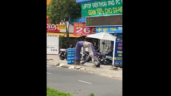 Air-filled advertisement mascot dances in Ho Chi Minh City