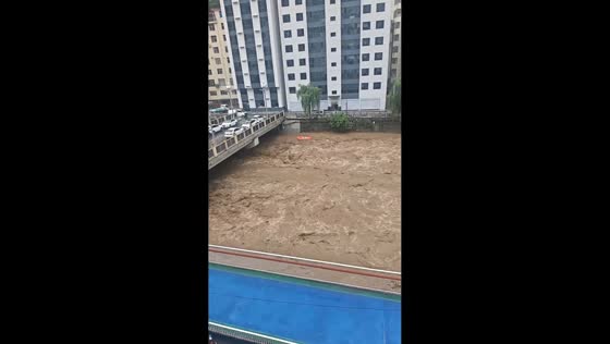 Swollen river surges beneath bridge after days of heavy rain in Shaanxi, China