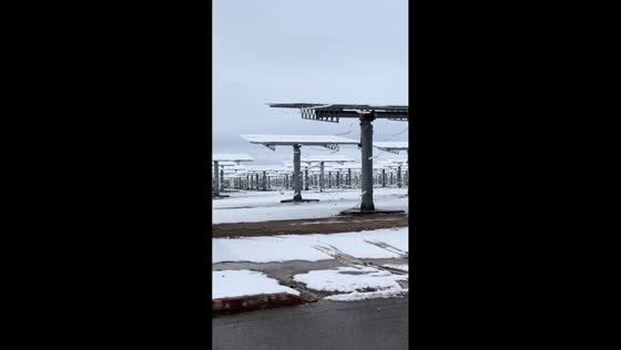 Snow slides off solar panels at Crescent Dunes Solar Energy Project, Nevada, USA