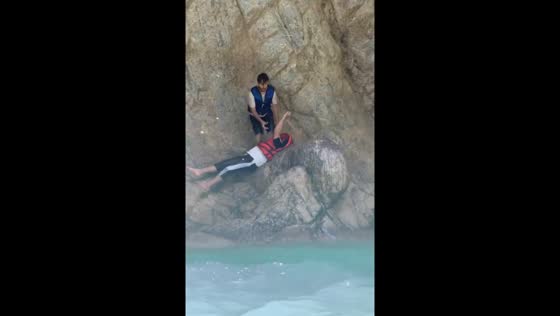 Person slips on rocks at Noori Waterfall, Pakistan