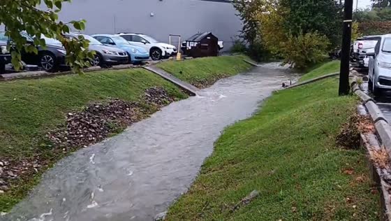 Creek swells into fast-flowing rapid after flash flooding in Lexington, Kentucky, USA