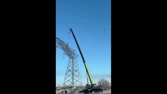 Crane lifted off the ground during power line support dismantling in Karaganda, Kazakhstan