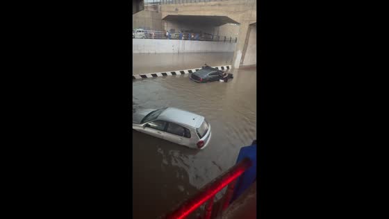 Severe flooding strands vehicles beneath railway in Sanhe, China