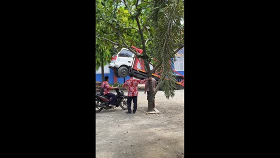 Truck tilts dramatically while unloading steel bars in Pati, Central Java, Indonesia