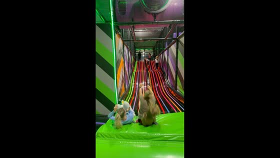 Sisters collide with another child on indoor slide in Sandusk, Michigan, USA