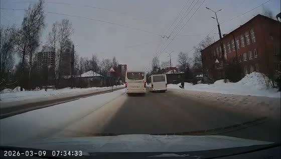Minibuses nearly hit pedestrian while driving side by side in Petrozavodsk, Russia