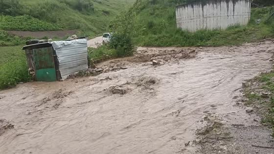 Car attempts to drive through flooded hillside road in Yunnan, China