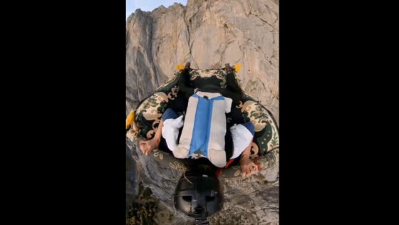 Adventurer takes leap from cliff on carpet in France