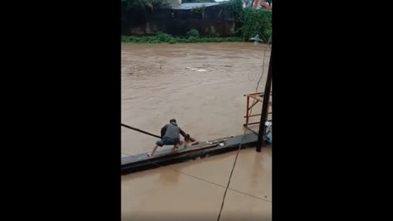 A man is saved from drowning in floods in Indonesia