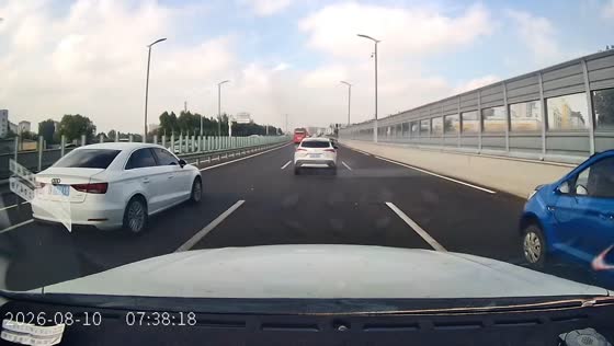 Car narrowly avoids a collision with a suddenly stopped vehicle on a highway in Shandong, China