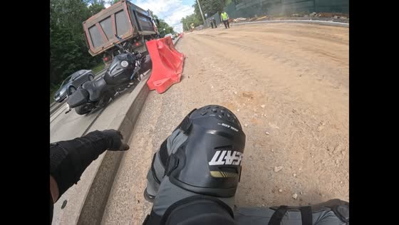 Motorcyclist tips over near a concrete curb in Moscow, Russia