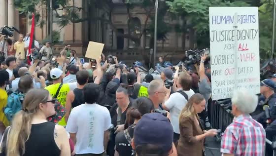 Police intervene as protesters gather near Town Hall in Sydney, Australia