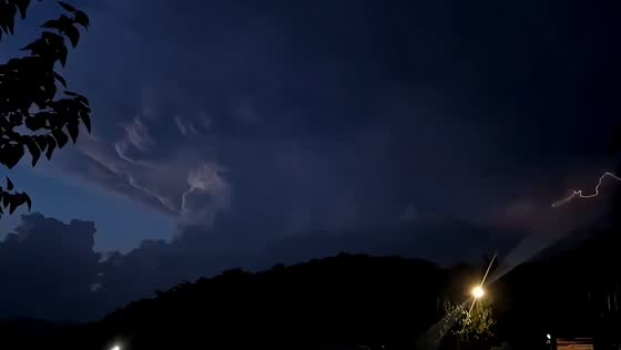 Distant lightning lights up storm clouds in Catalonia, Spain