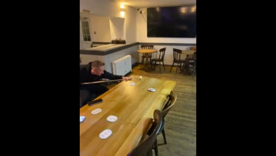 Man performs incredible billiard trick shot from dining table in Cardiff, UK