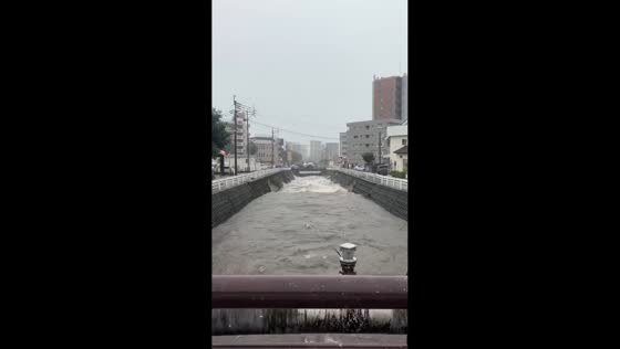 Floodwaters surge through Kengun River in Kumamoto, Japan