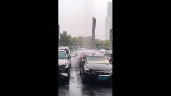 Heavy rain creates a rain shaft over a car in Liaoning, China