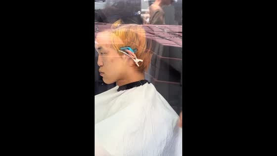 Barber uses clips to pin back customer's ears in Inner Mongolia, China