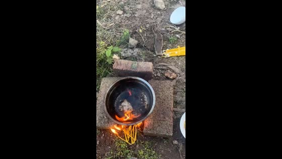 Children play at cooking with makeshift outdoor stove in Yunnan, China