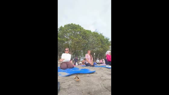 Unexpected wave interrupts beach yoga in Pangandaran, Indonesia