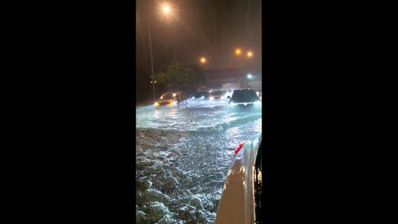 Heavy rain inundates city roadway at night in Taiyuan, China