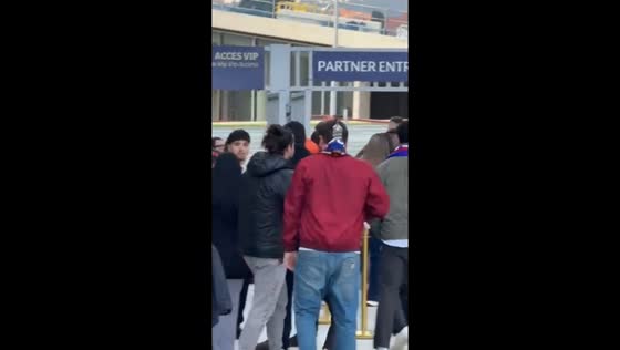 Man attends stadium match with whiskey strapped behind his head in Barcelona, Spain