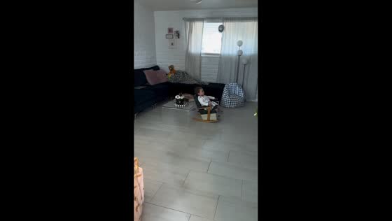Toddler enjoys thrifted rocking chair, Tucson, Arizona, USA