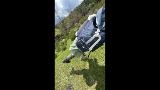Man playfully trips friend during mountain hike in Valdeblore, France