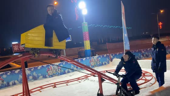 Man rides bicycle-powered cart on roller coaster track in Liaoning, China