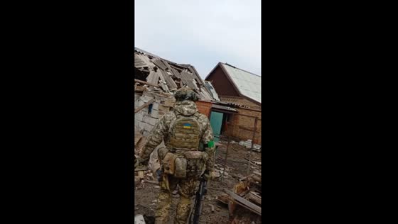 Ukrainian soldiers navigate through abandoned war-torn homes in Bakhmut