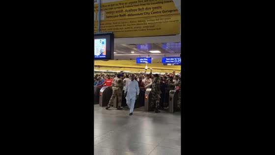 Protesters rush toward Delhi Metro station during protest in Delhi, India