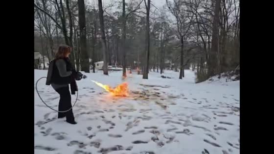 Woman uses flamethrower to clear snow in Trussville, Alabama, USA