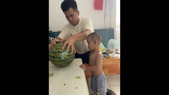 Dad accidentally bumps son's head while cutting watermelon in Guangxi, China