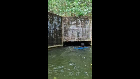 Swimmers navigate water tunnel in Puerto La Cruz, Venezuela