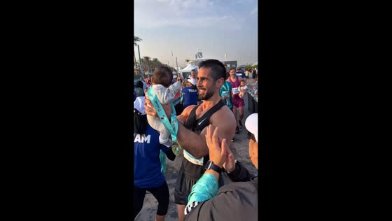 Father crosses half marathon finish line with toddler in Dubai, UAE