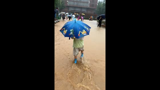 Severe flooding surrounds school as people walk through heavy rain in Sichuan, China