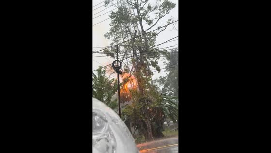 Sudden tree explosion near electric pole during heavy rain in Padang Batung, Indonesia