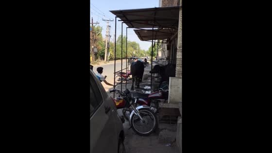 Runaway bull knocks down motorbike in Faisalabad, Pakistan
