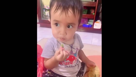 Toddler reacts after tasting spicy chili in Batam, Indonesia
