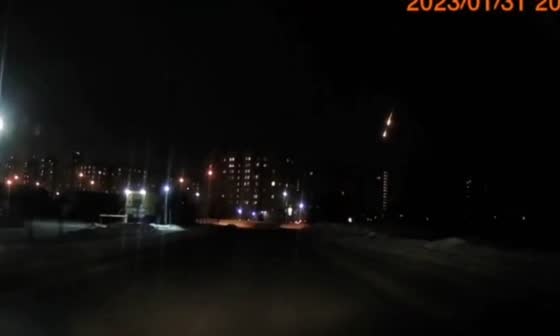 An unidentified object lights up the sky, caught by a car dash cam
