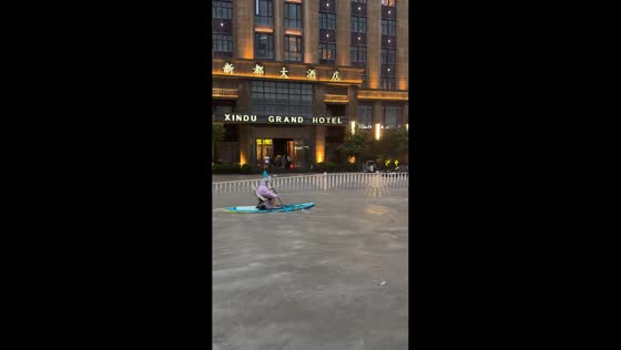Man paddles through severely flooded street in Zhejiang, China