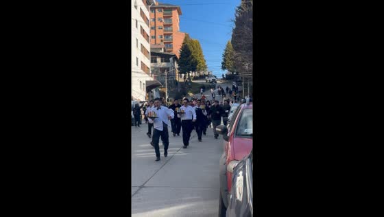 Waiters race while carrying food products in San Carlos de Bariloche