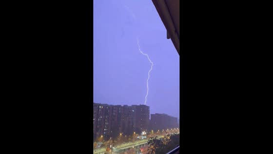 Powerful lightning strike illuminates sky during thunderstorm in Barcelona, Spain