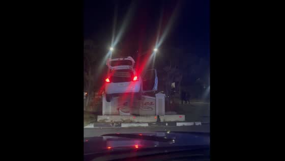 Car ends up on top of concrete sign in Providenciales