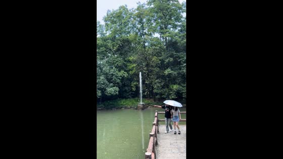 Woman shouts to trigger manually operated fountain in Hangzhou, China