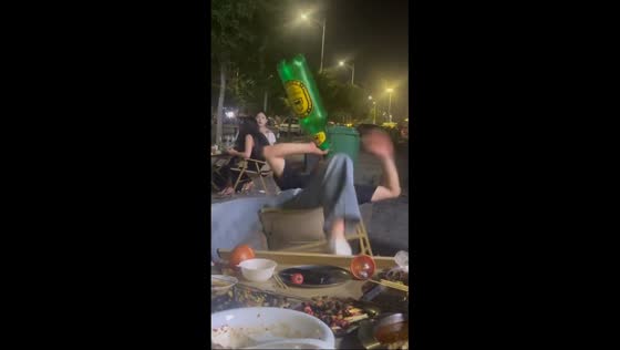  Man falls over after finishing giant liquor bottle in Henan, China